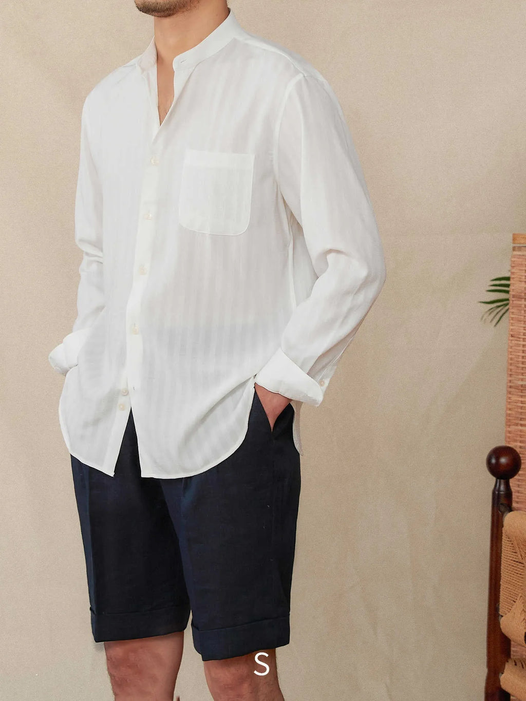 Blue and white striped seersucker long sleeve shirt with a loose lapel and baseball collar.