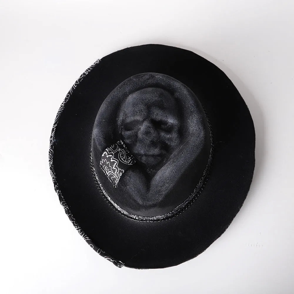 Handmade black wool felt skull hat with conical crown and textured denim-like finish.