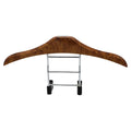 Wood yellow stainless steel car clothes hanger for suits and coats on a vehicle headrest.