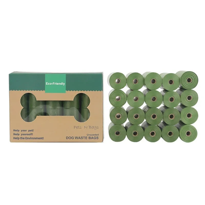 A roll of green EPI degradable pet waste bags next to a black dispenser on a grass background.