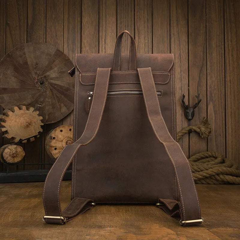 Dark brown genuine leather travel bag with shoulder straps and organised internal compartments