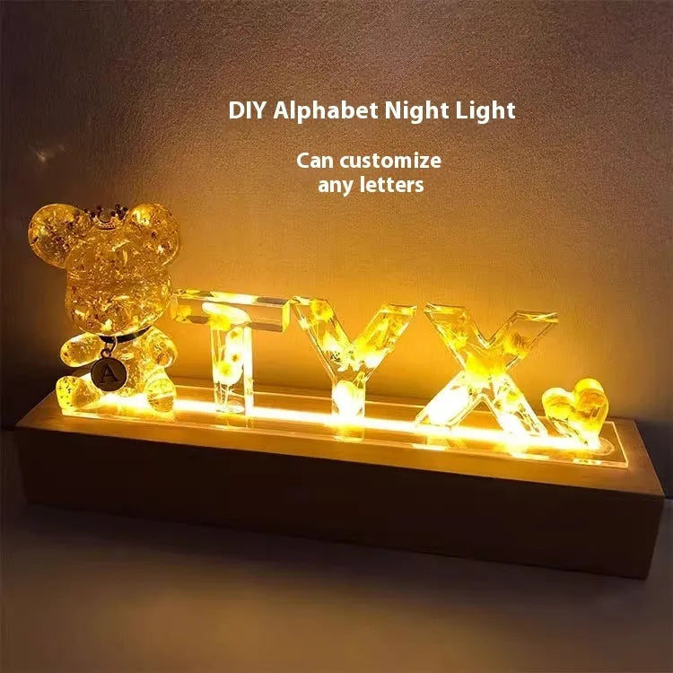 Letter small night lamp with dried flowers, blue colour, warm light, on a table
