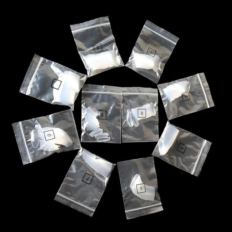 Clear transparent ABS false nails in a pack of 500 pieces, showing French tip design and range of sizes.