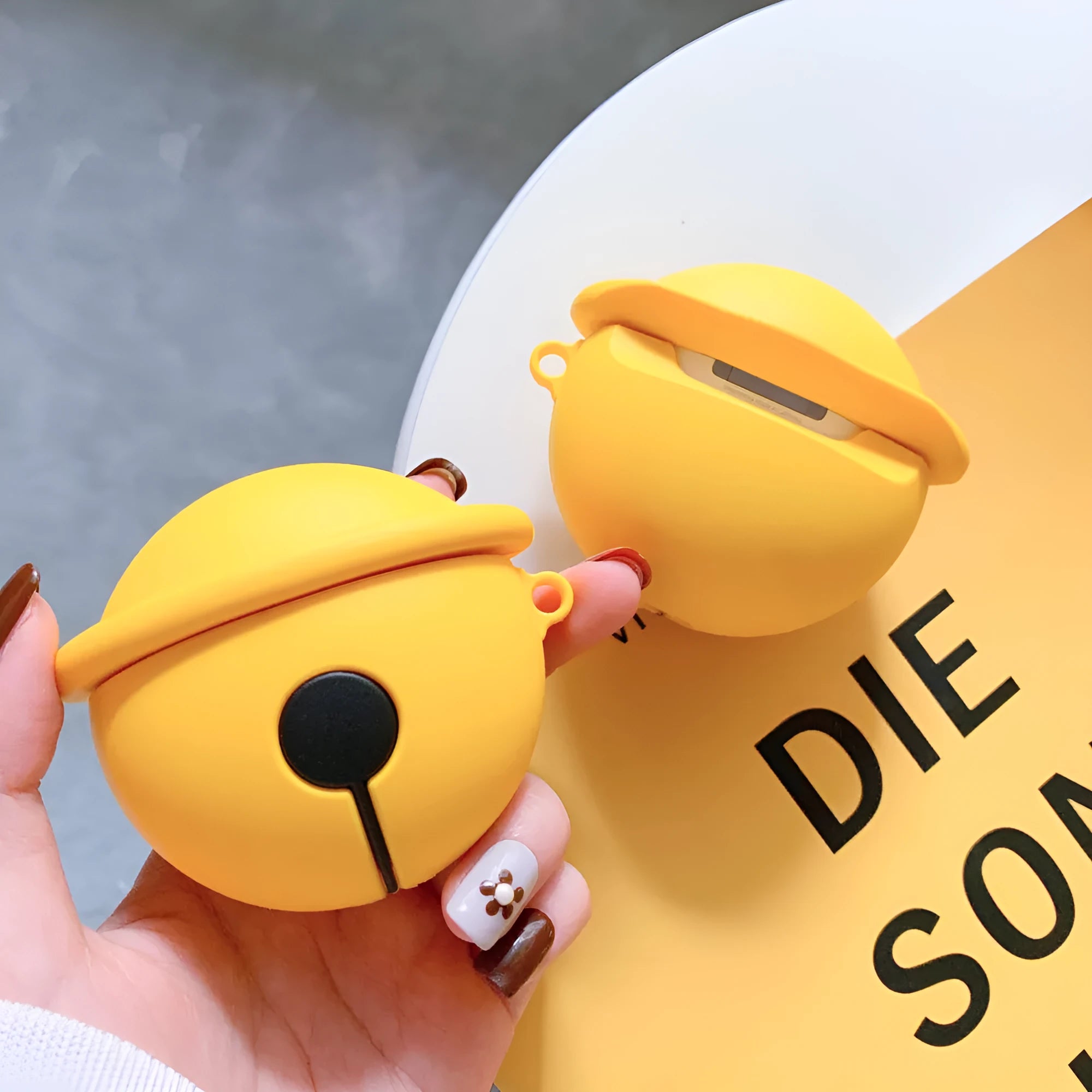 Yellow silicone AirPods case with bell design for 1st and 2nd generation headphones