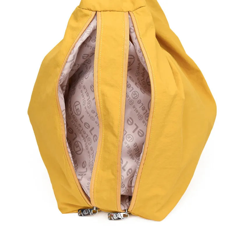 Soft heart-shaped nylon underarm bag for women shown in black, blue, khaki, and yellow.