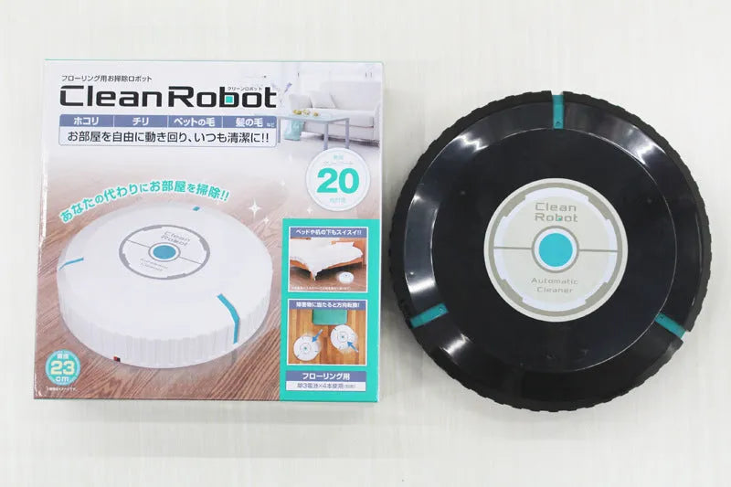 Black and white compact AC automatic sweeping robot vacuum cleaner on a wooden floor.
