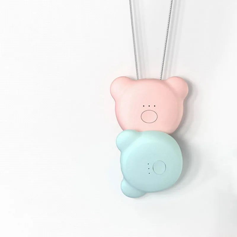 Pink portable USB air purifier necklace with charging cable showing compact wearable design