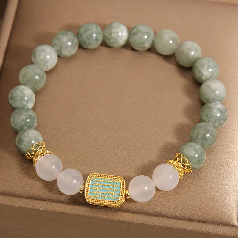 Women's oil green emerald crystal bracelet with five-piece sutra design on wrist.