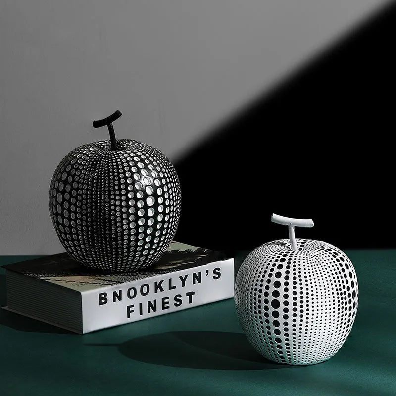 Resin apple and pear ornaments, black high model 17cm by 14cm and white low model 16cm by 12cm.