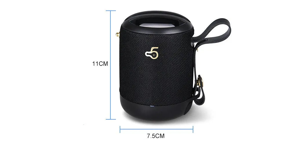 Compact black waterproof bluetooth speaker with portable belt on a table