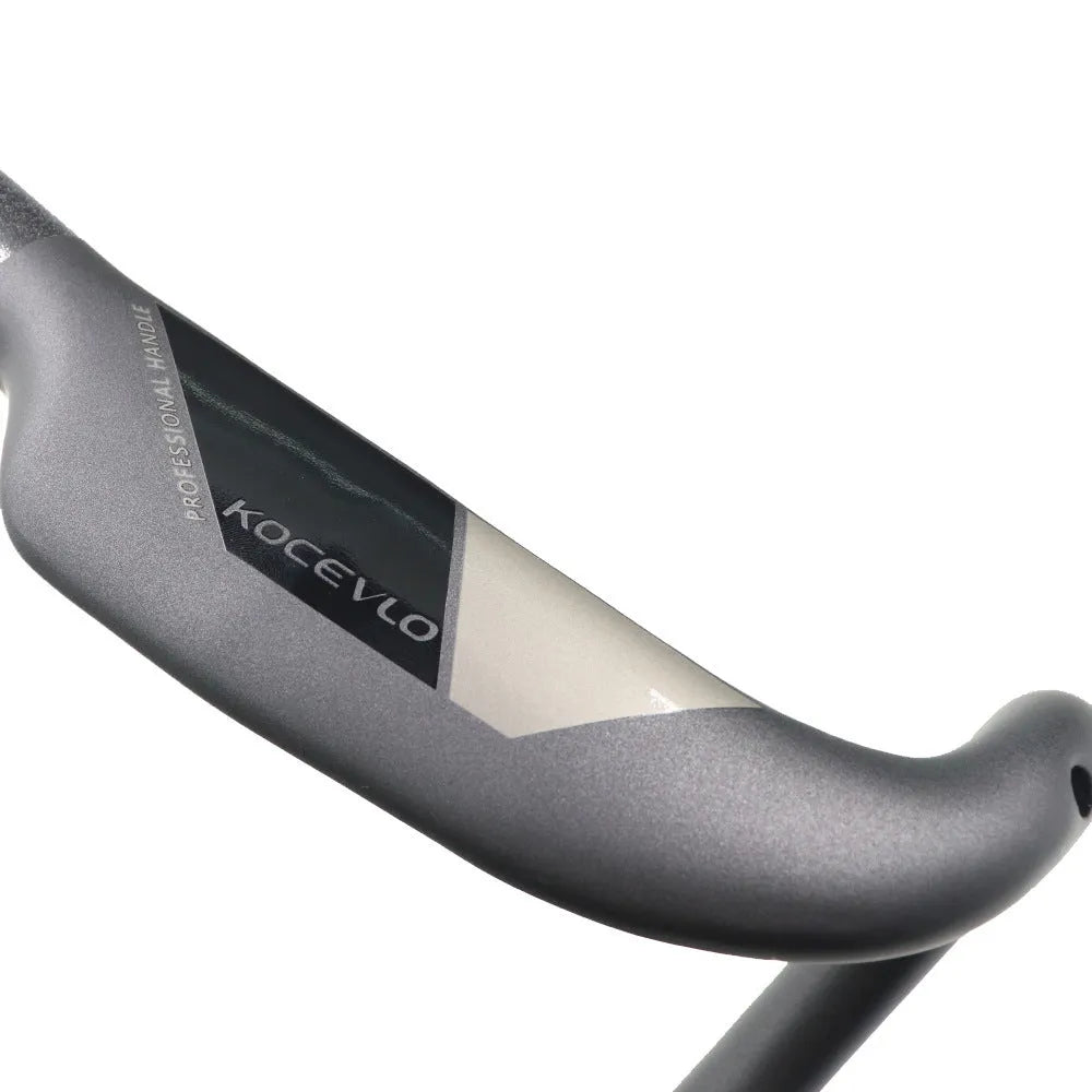 Matt black carbon fibre road bike handlebar with shallow drop, shown from a top-down angle.