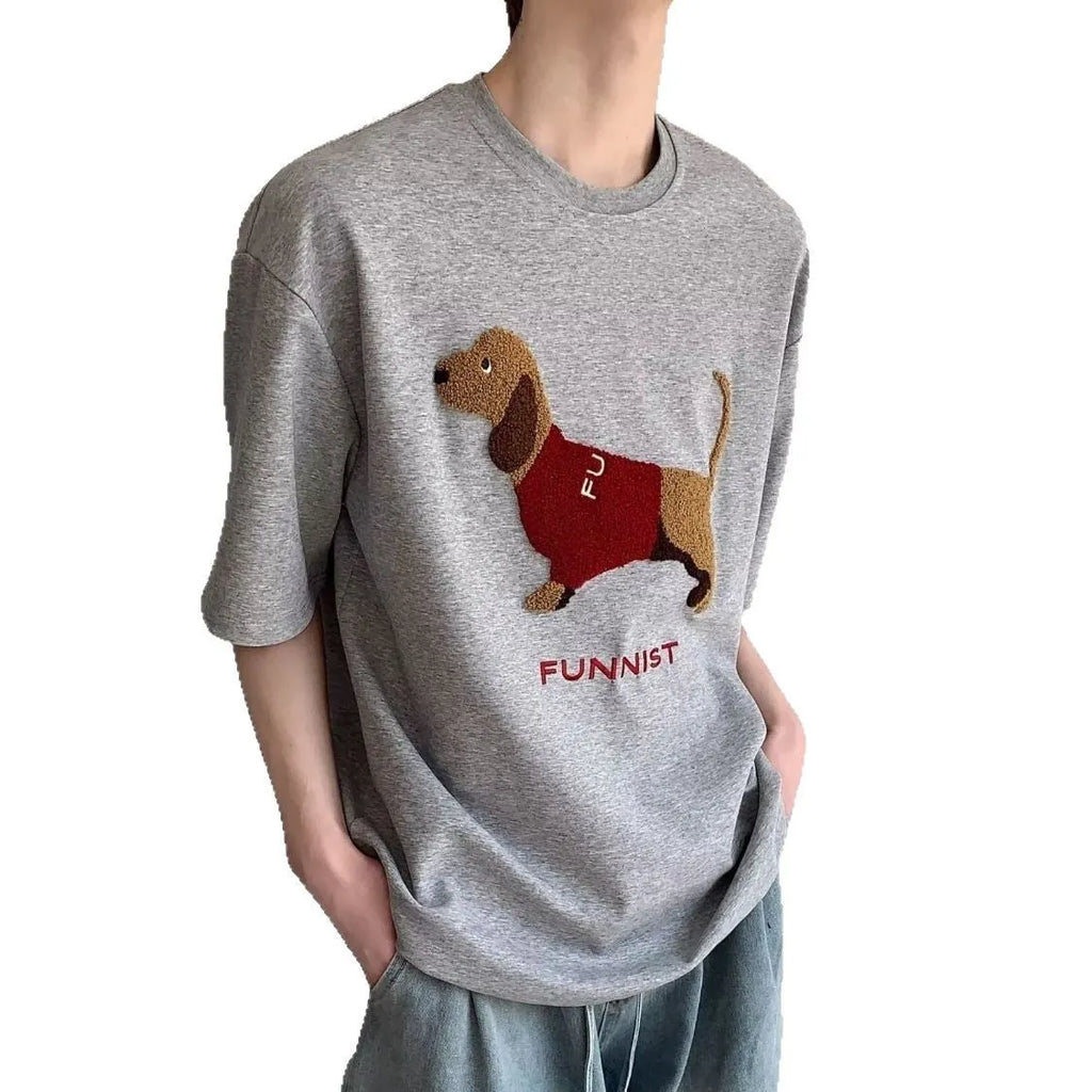 Men's gray cotton t-shirt with an embroidered cartoon sausage dog holding a blue towel.
