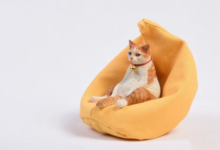 Lazy cat car ornament figure on fabric sofa, 7.5cm high resin model decoration.