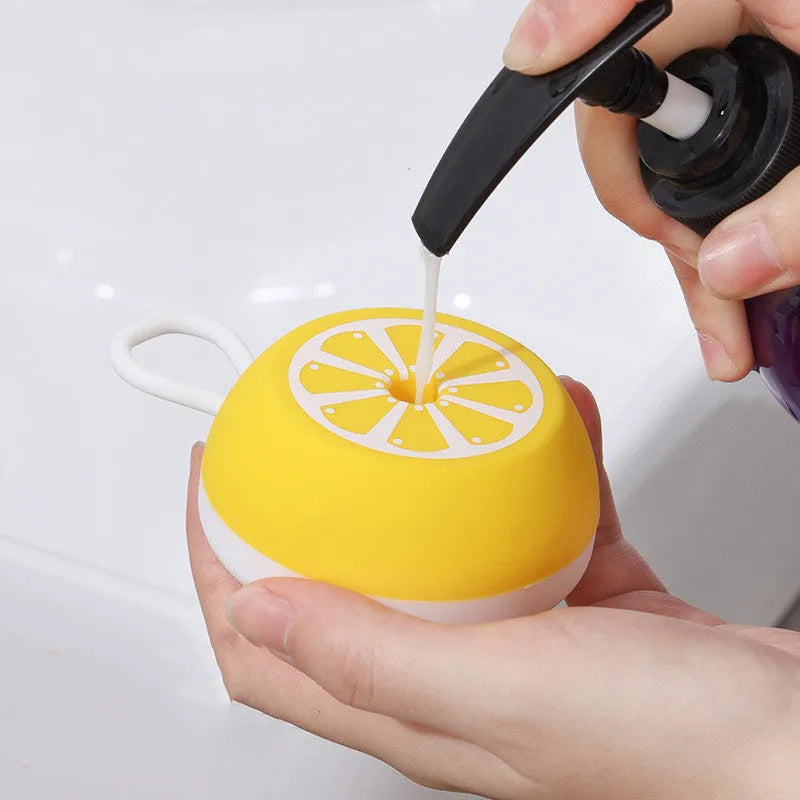 Yellow silicone pet bath brush with comb teeth and massage nodes on a 2-in-1 head.