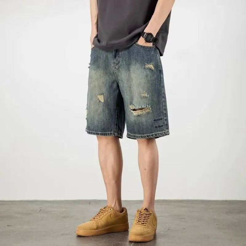 Blue retro loose-fit men's denim shorts with distressed holes and a straight-leg cut