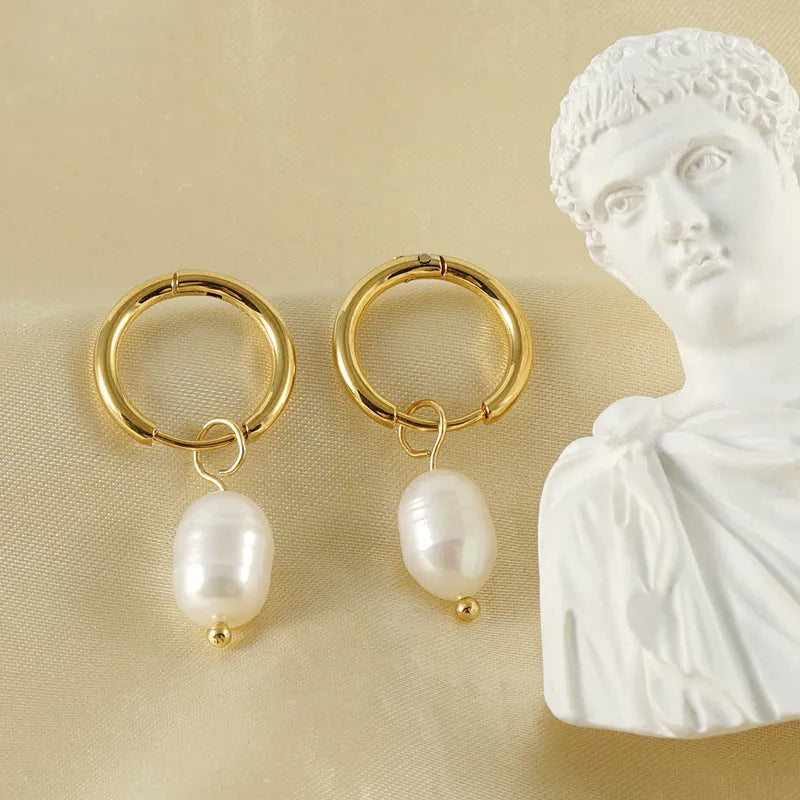 A pair of gold geometric earrings for women with pearl accents, made from stainless steel.