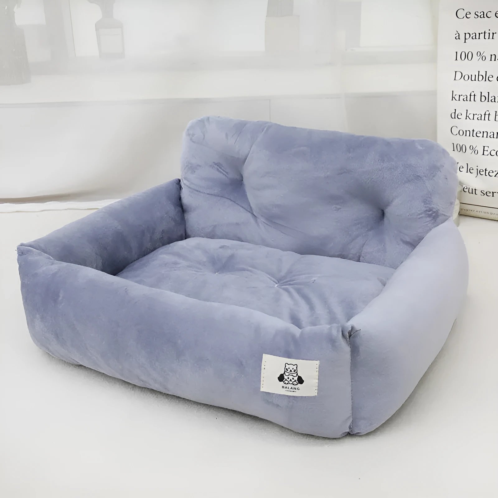 Grey and blue plaid cloth dog bed designed for car travel, shown in small and large sizes.