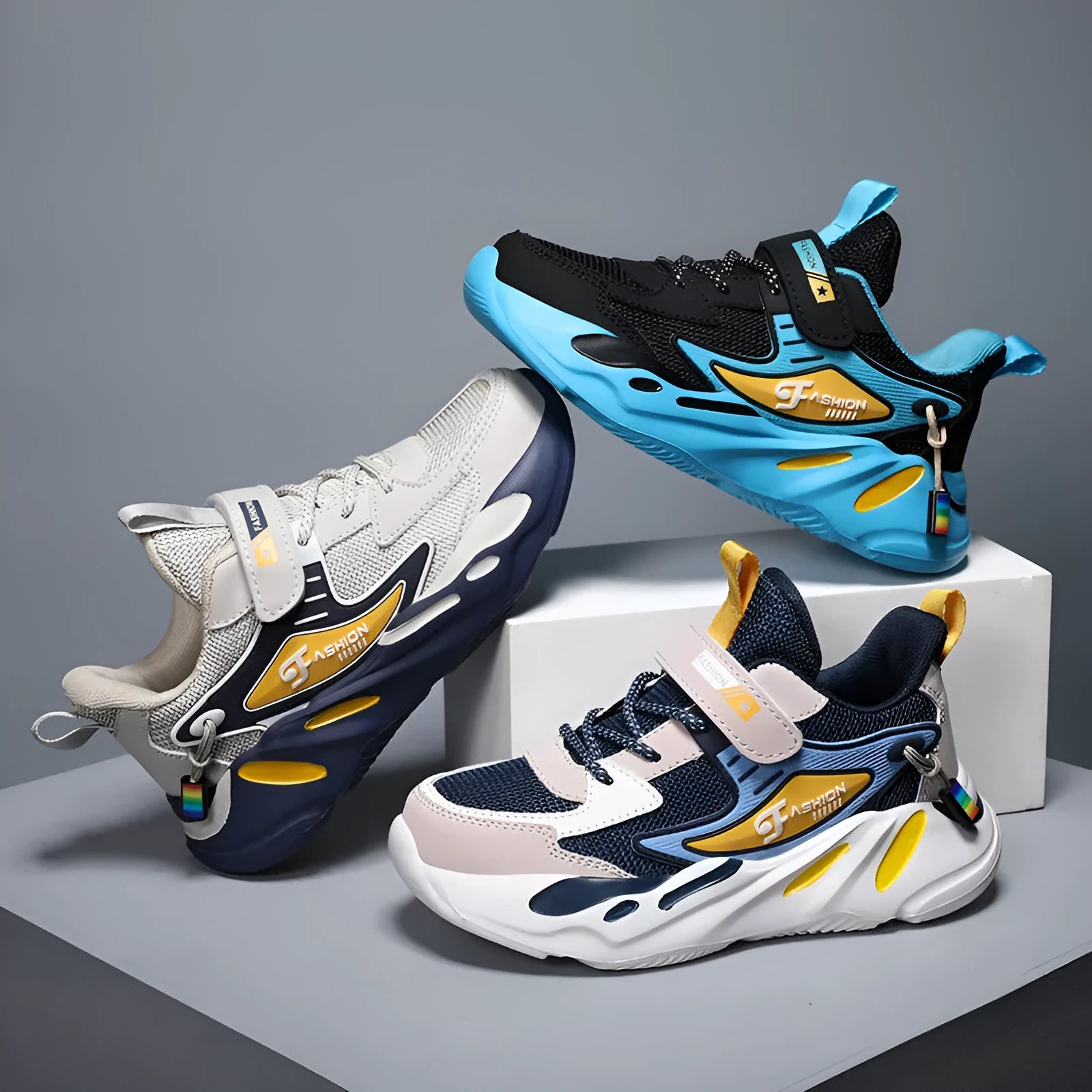 Boy's blue sports running shoe with velcro strap and mesh upper on a hard ground surface.
