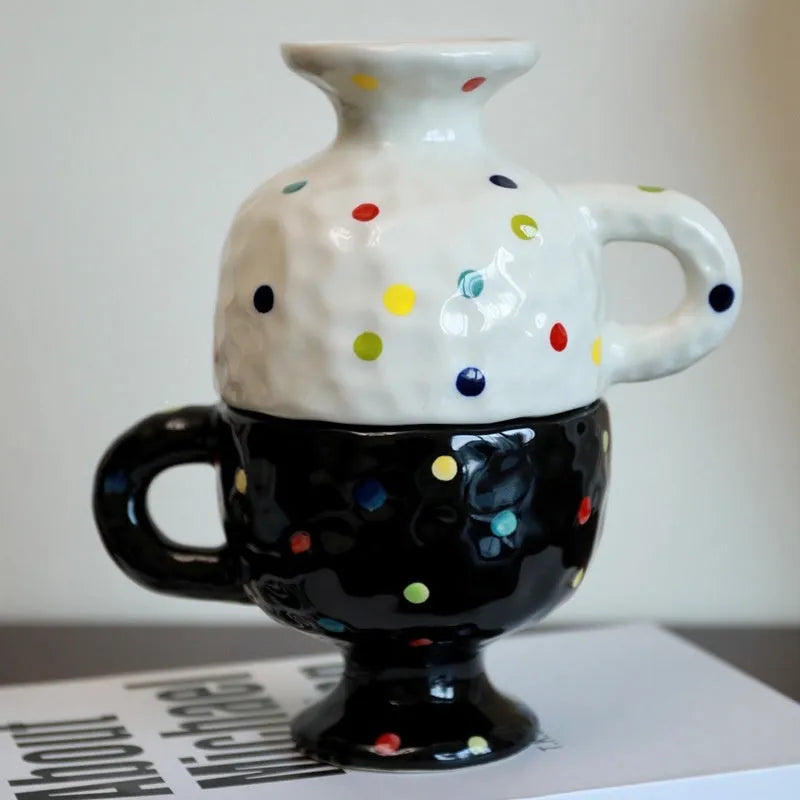 Handmade irregular solid colour ceramic mug on a table, showing its unique shape.