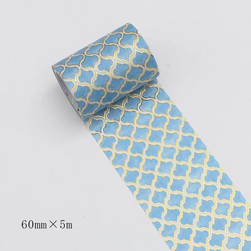Roll of Alice in Wonderland themed decorative tape with a bronzed finish on Japanese paper, showing colour options.