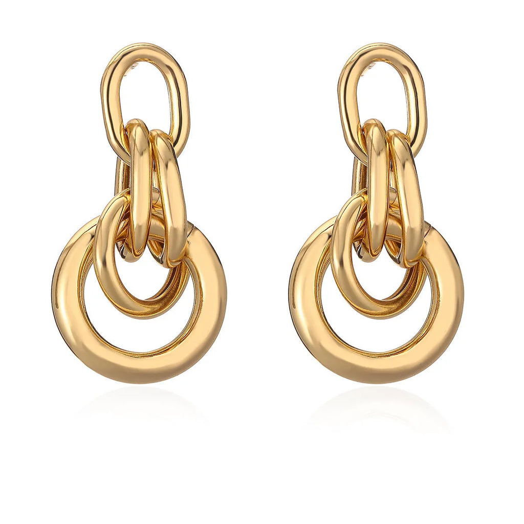 Gold geometric drop earrings with irregular design elements on copper base