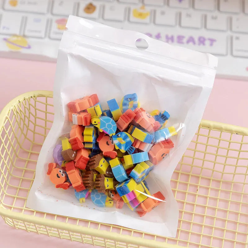 Sealed plastic bag containing 50 small cartoon-themed erasers in shapes like fruits, animals, and Christmas symbols.