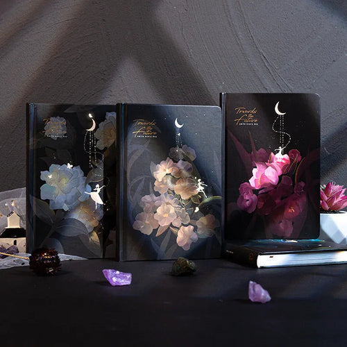 A5 notebook with luminous reflective cover open to show pages with colourful illustrated backgrounds.