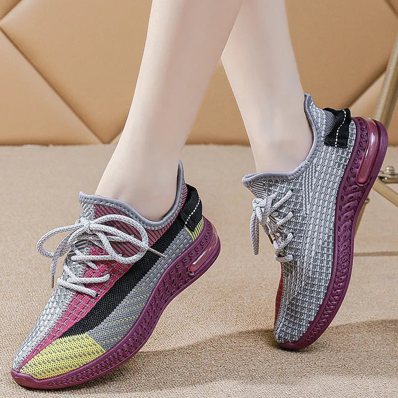 Women's lightweight casual running shoe in purple with front lace-up, round toe, and flat heel.