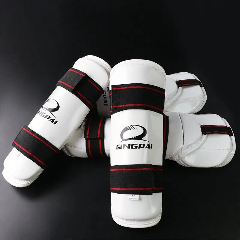 Taekwondo arm guards and leg protectors set in black PU EVA foam on a white background.