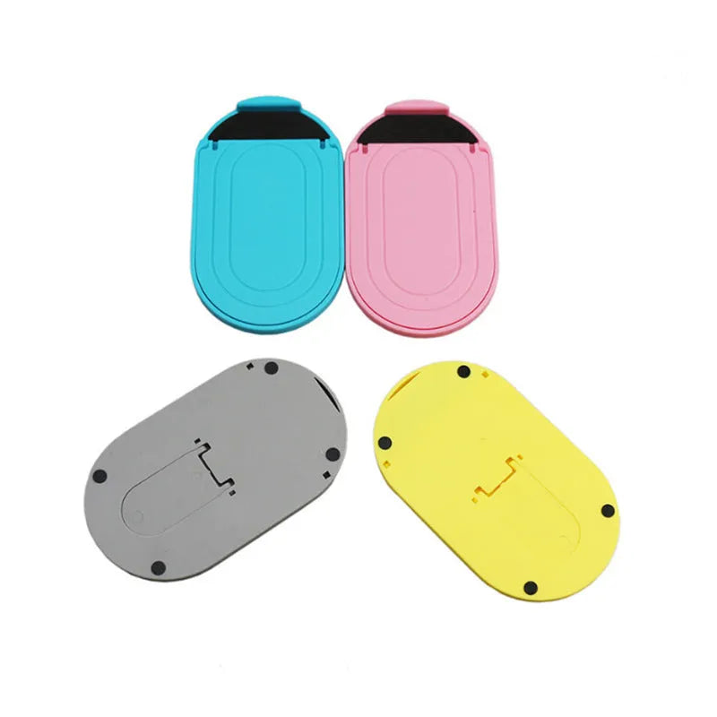 Plastic lazy bracket phone stand holding a mobile phone, shown in multiple colour options