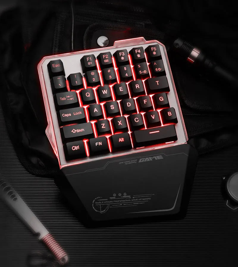 Black G40 Flow one-handed robotic gaming keyboard with RGB backlit keys on a desk.