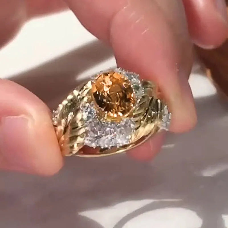 Embossed feather ring with geometric design and inlaid yellow zircon in gold colour