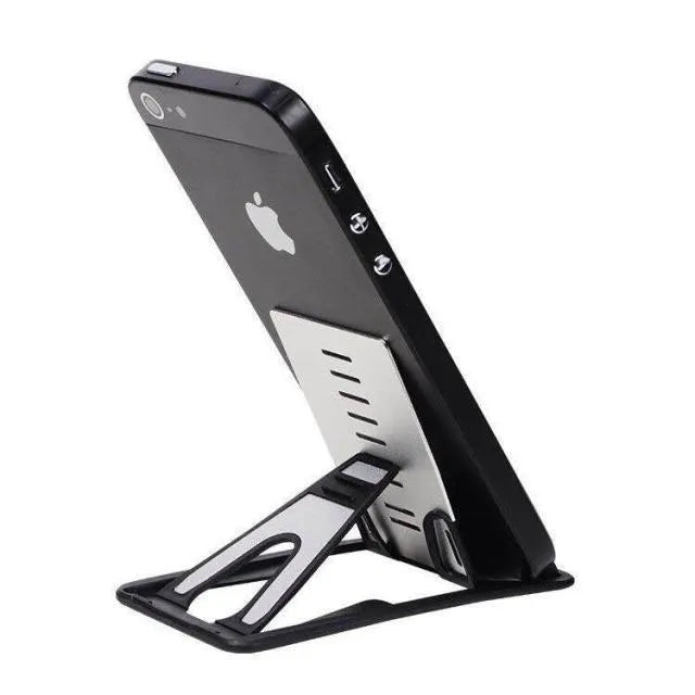 Black desktop card phone holder on a wooden desk next to a mobile phone and credit cards