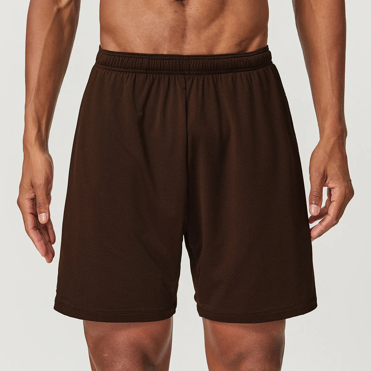 Men's quick-dry double-layer running shorts in a brick red colour on a mid-waist fit model.