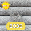 Oval denier fashion ring with open mouth setting, five-pointed star, and 6x8mm stone on copper band.