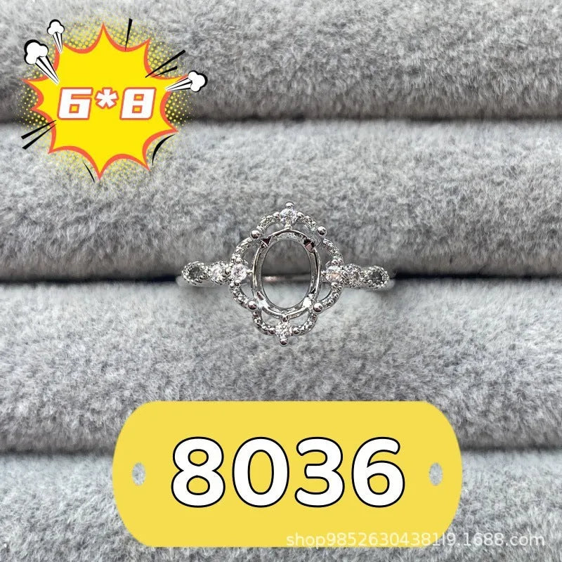 Oval denier fashion ring with open mouth setting, five-pointed star, and 6x8mm stone on copper band.