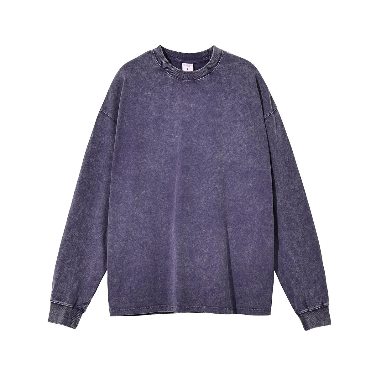 Man wearing a loose-fit batik print long sleeve cotton pullover top in a vintage washed colour.