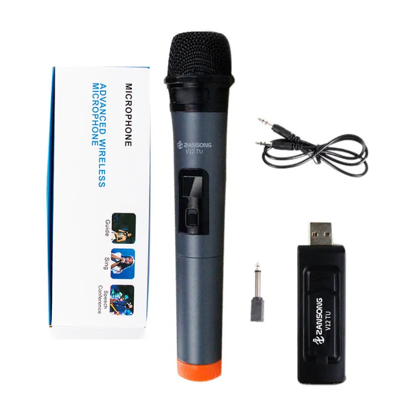 Black handheld dynamic microphone with USB receiver and cables on a table.