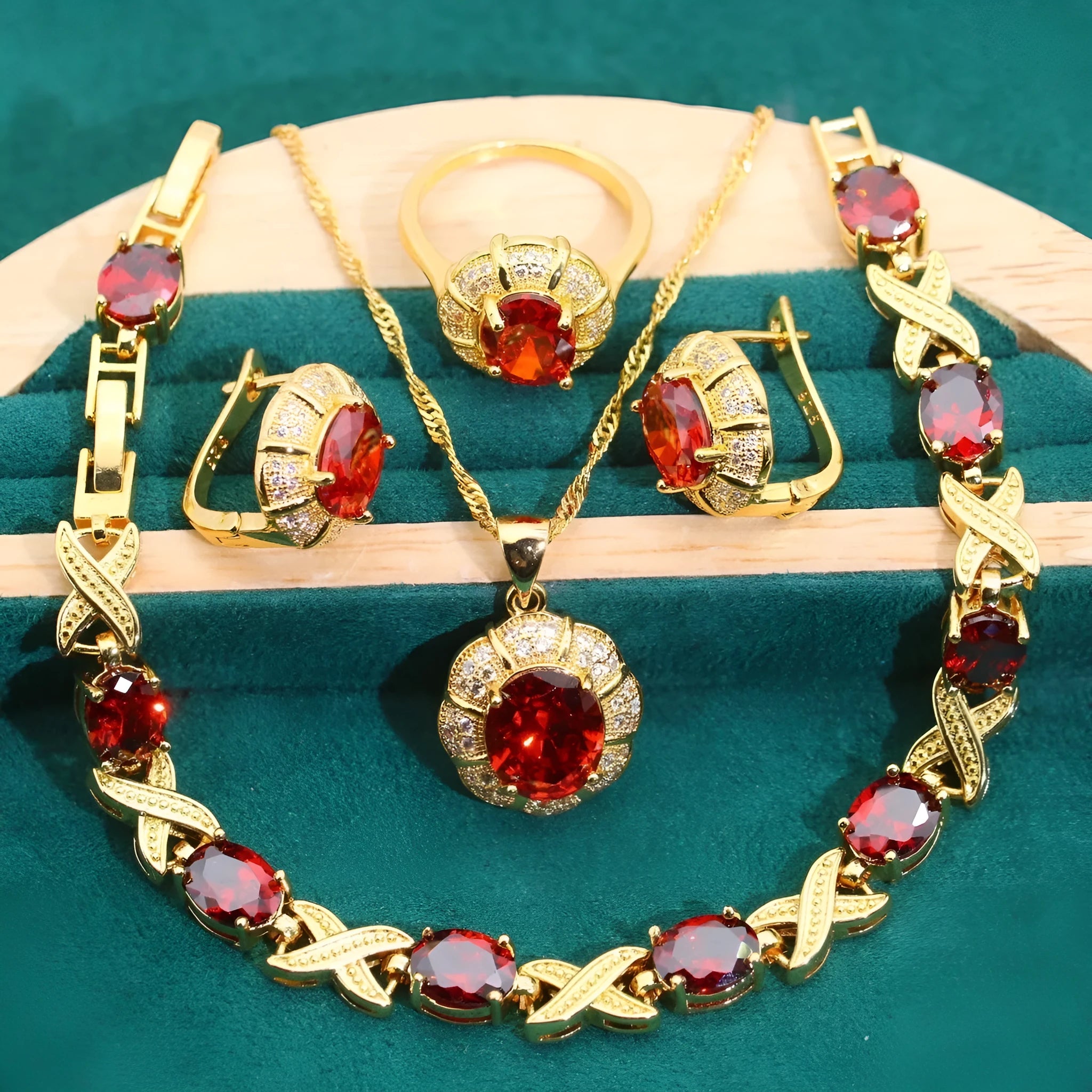 18k gold plated zircon jewellery set with necklace, earrings, ring, and bracelet on blue background