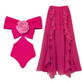 Women's floral hollow-out patterned one-piece swimsuit with optional matching skirt on a hanger.