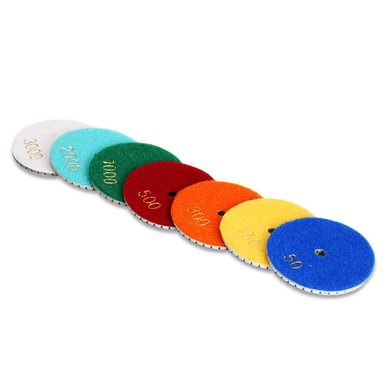 Set of 10 stone polishing pads with emery abrasive, showing 80mm diameter and central 10mm hole.