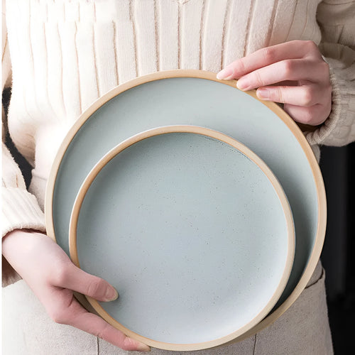 10-inch pure blue matte finish ceramic dinner plate on a table.