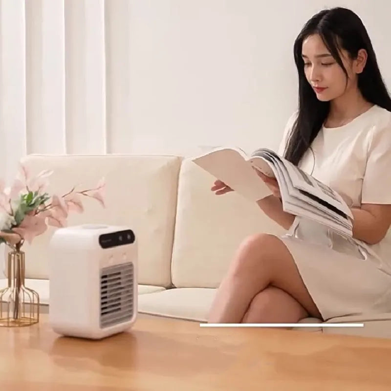 Ivory white portable air cooler with touchscreen panel and USB cable on a desk
