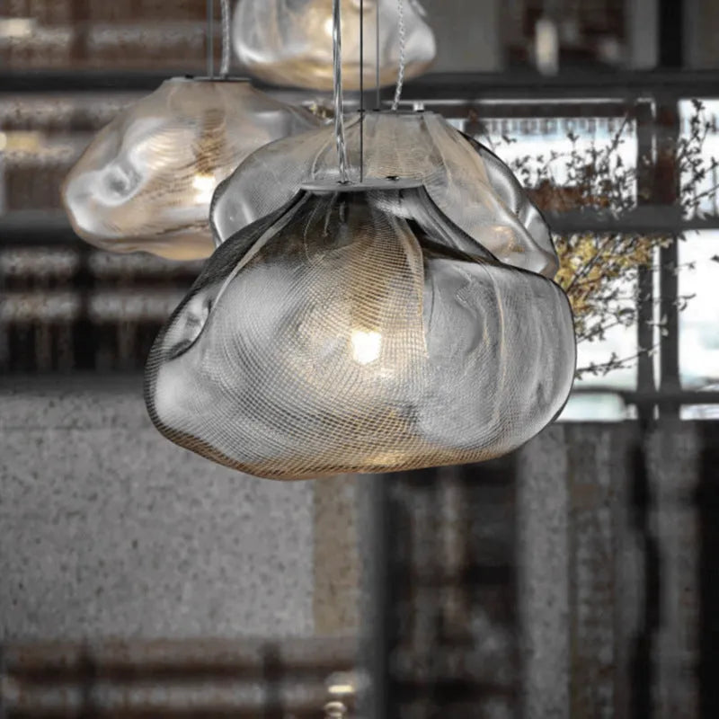 Postmodern style fabric chandelier with glass shade, shown in amber, clear, and smoke grey colours.