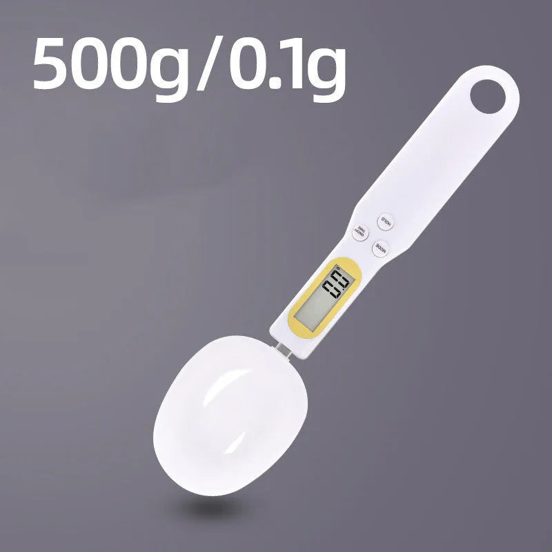 Black electronic digital scale with integrated measuring spoon showing weight display.