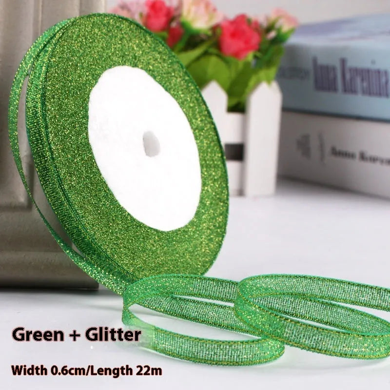 Roll of narrow 0.6cm wide polyester gift ribbon in a multicolour pattern.