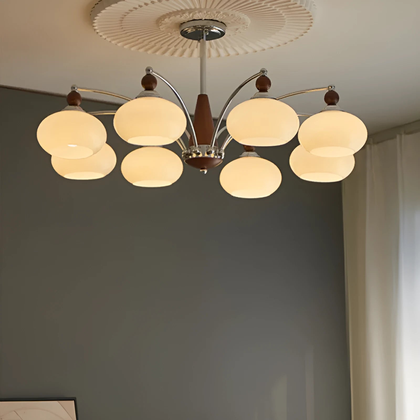 Persimmon glass and chrome chandelier with multiple glass lampshades in a choice of colours.