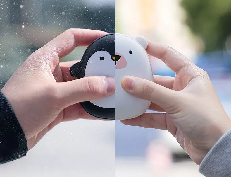 Cartoon penguin polar bear USB rechargeable hand warmer and power bank unit.