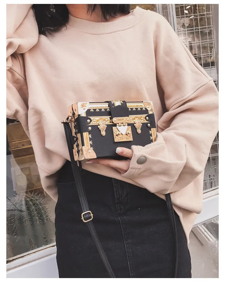 Women's black structured PU leather flap shoulder bag with cross-body strap and rivet details.