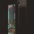 USB gaming keyboard with multi-colour backlight in a compact black and green design on a desktop
